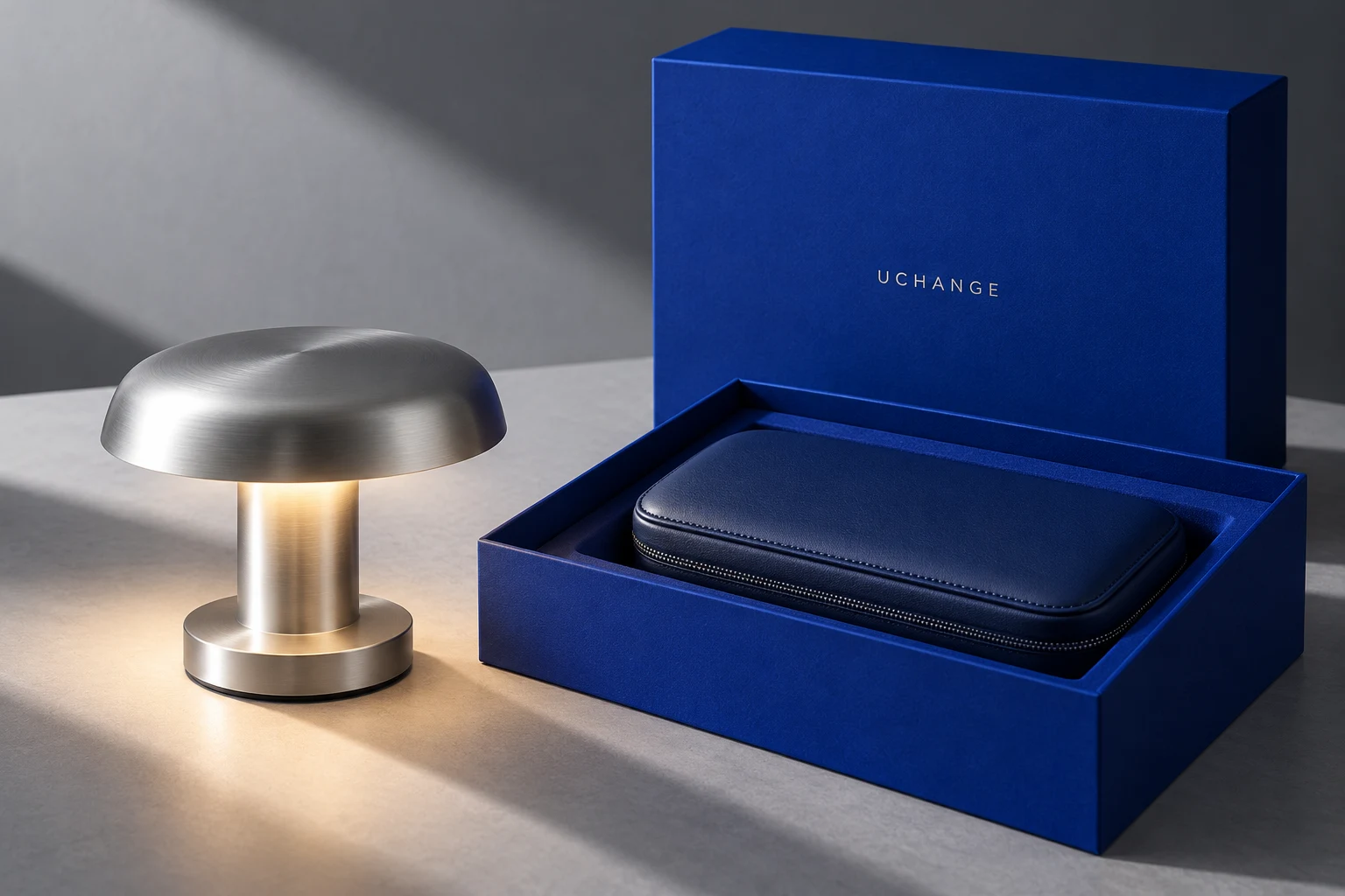 Concept design of a sculptural aluminum lamp and midnight-blue leather case with a cobalt UCHANGE presentation box
